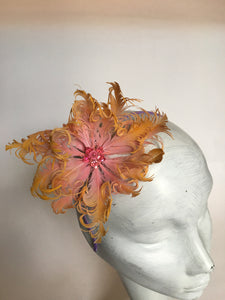 Pink and yellow feather flower with net on a lilac silk headband.