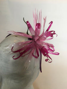 Pink recycled plastic flower on a silk covered metal headband.