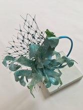 Load image into Gallery viewer, Turquoise and green recycled plastic flower on a turquoise silk metal covered headband.